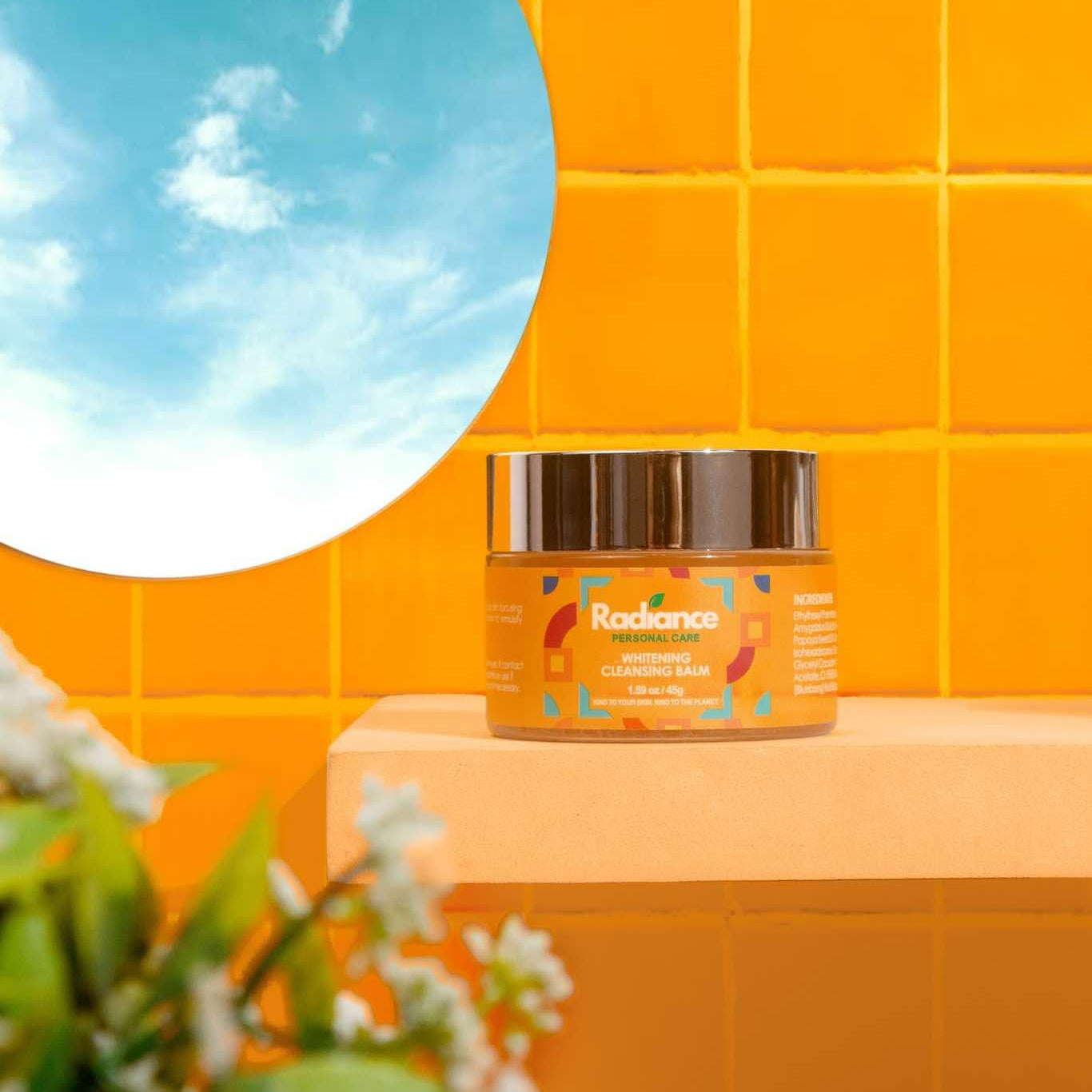Jar of Radiance skincare product on a yellow tiled wall with a round mirror and plant.